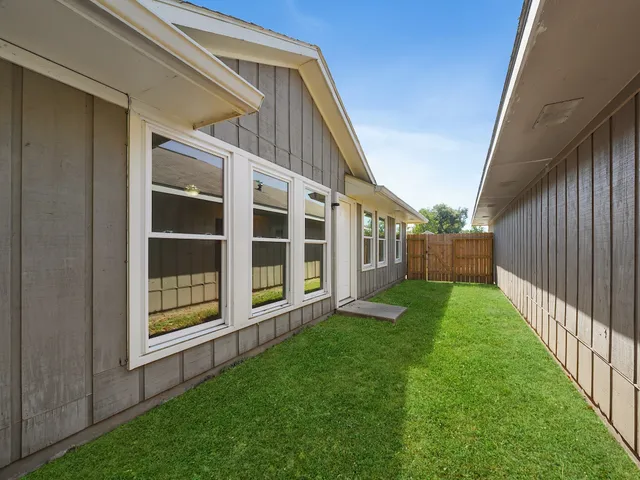 a view of an house with backyard and porch