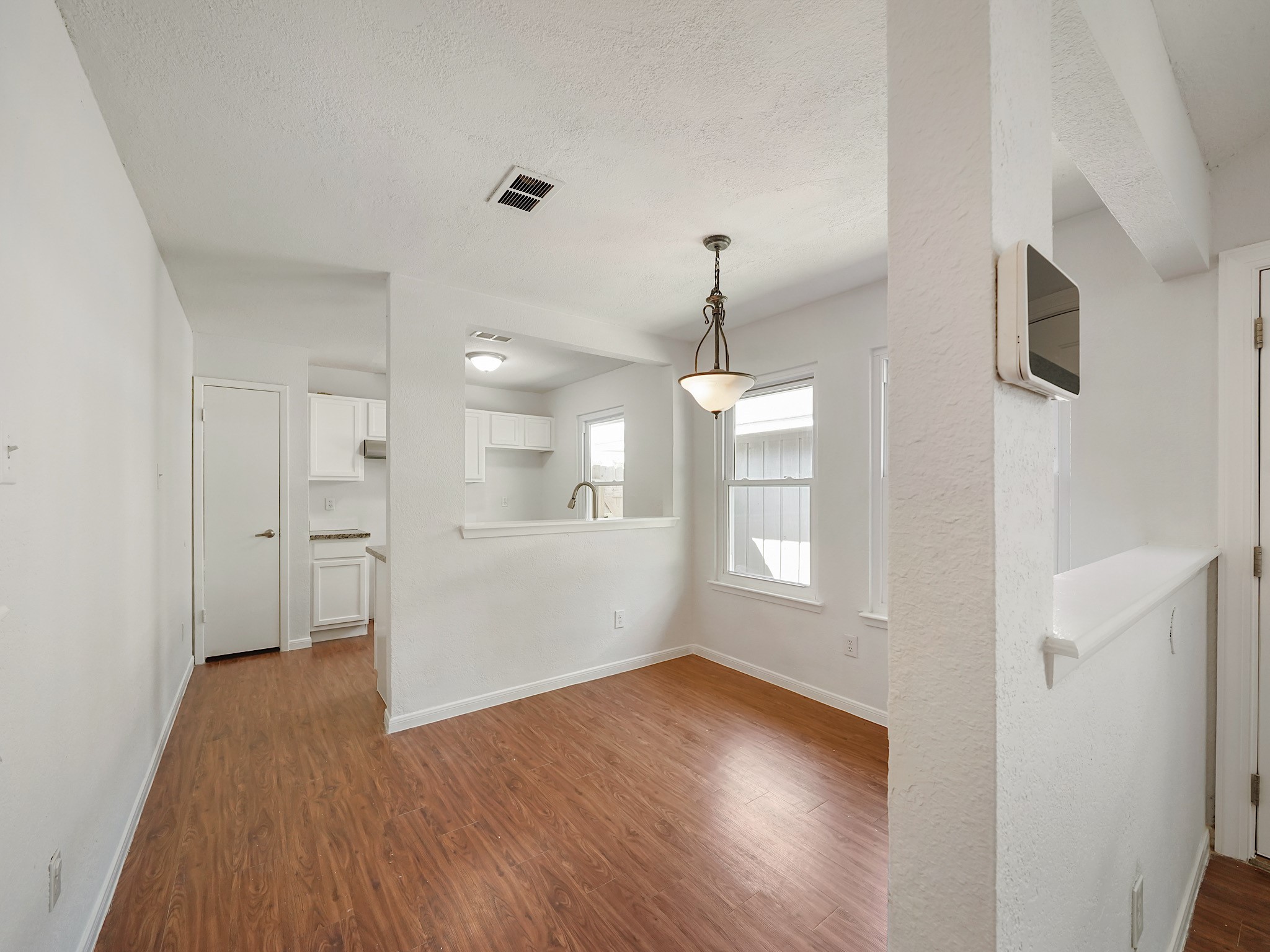 23338 Prairie Bird Drive Spring, TX 77373 - Photo 8 of 18 a view of empty room with wooden floor and window