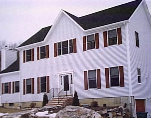 270 Boston Road Sutton, MA 01590 - Photo 1 of 1 a front view of a house with a yard