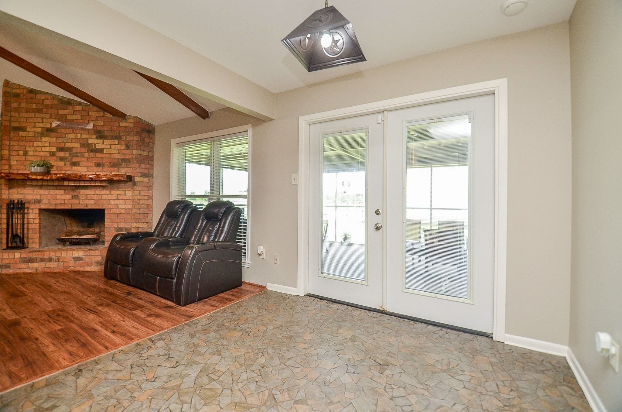 2500 County Road 62 Rosharon, TX 77583 - Photo 15 of 48 a living room with furniture a fireplace and a floor to ceiling window