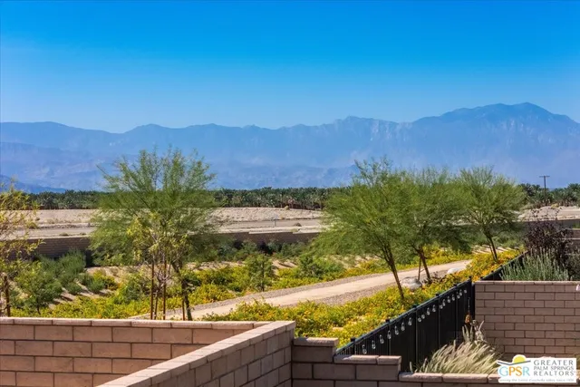a view of a house with porch and garden