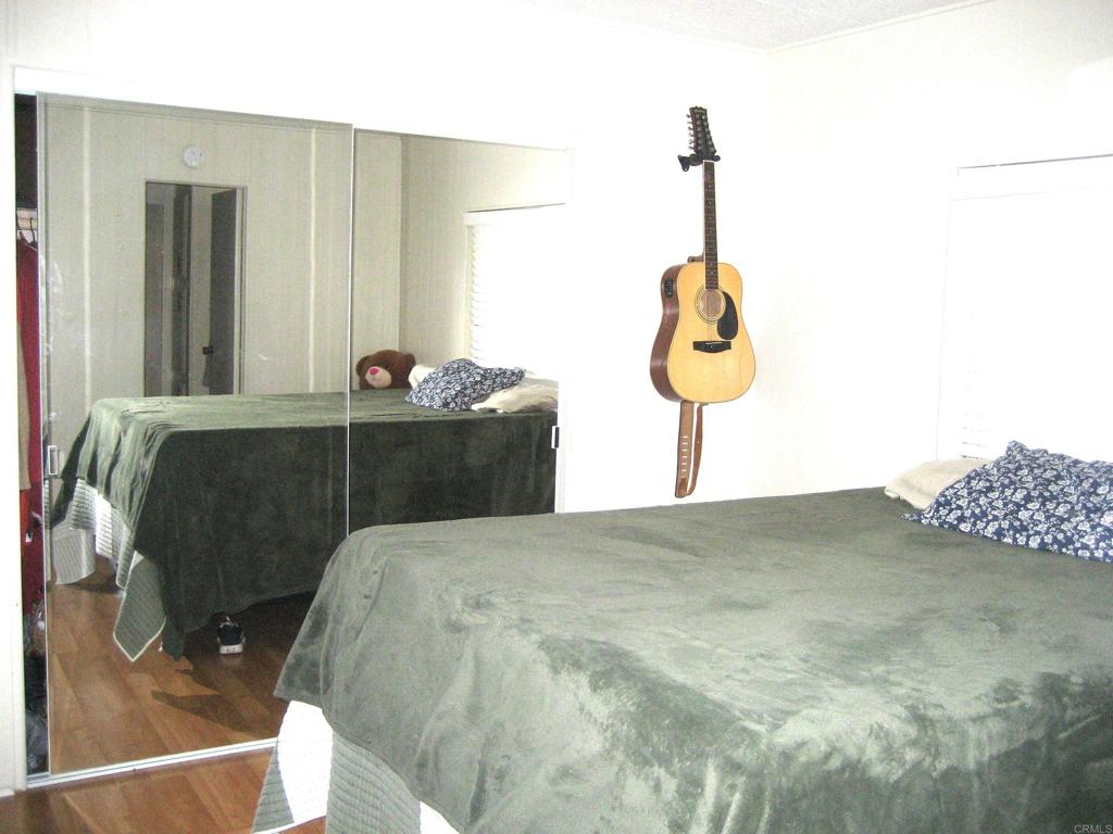 1175 La Moree Road, Unit 33 San Marcos, CA 92078 - Photo 15 of 18 a bedroom with a bed and chandelier