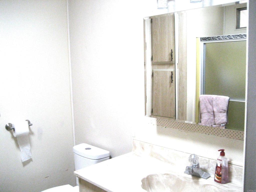 1175 La Moree Road, Unit 33 San Marcos, CA 92078 - Photo 16 of 18 a bathroom with a sink and a mirror