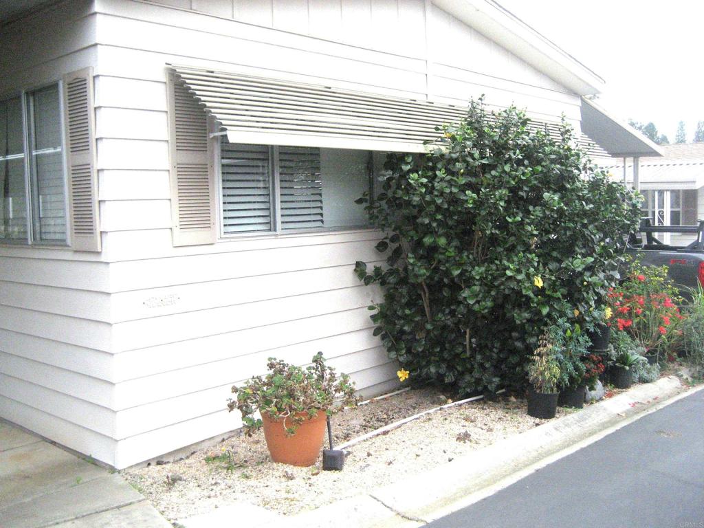 1175 La Moree Road, Unit 33 San Marcos, CA 92078 - Photo 4 of 18 a potted plant sitting in front of a house