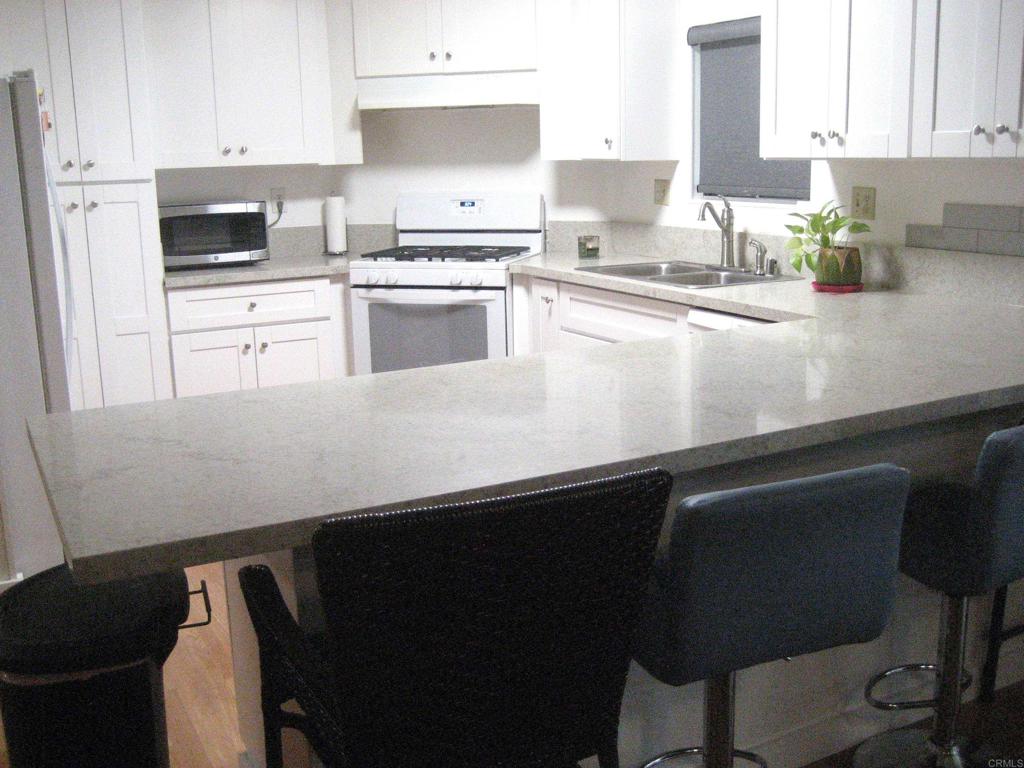 1175 La Moree Road, Unit 33 San Marcos, CA 92078 - Photo 8 of 18 a kitchen with a sink cabinets and stainless steel appliances
