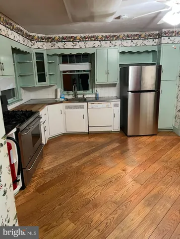 a view of a room with wooden floor