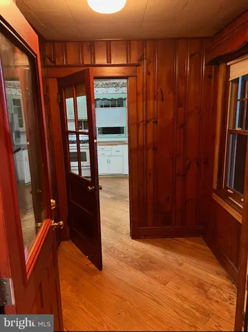 a view of a livingroom with wooden floor and a window