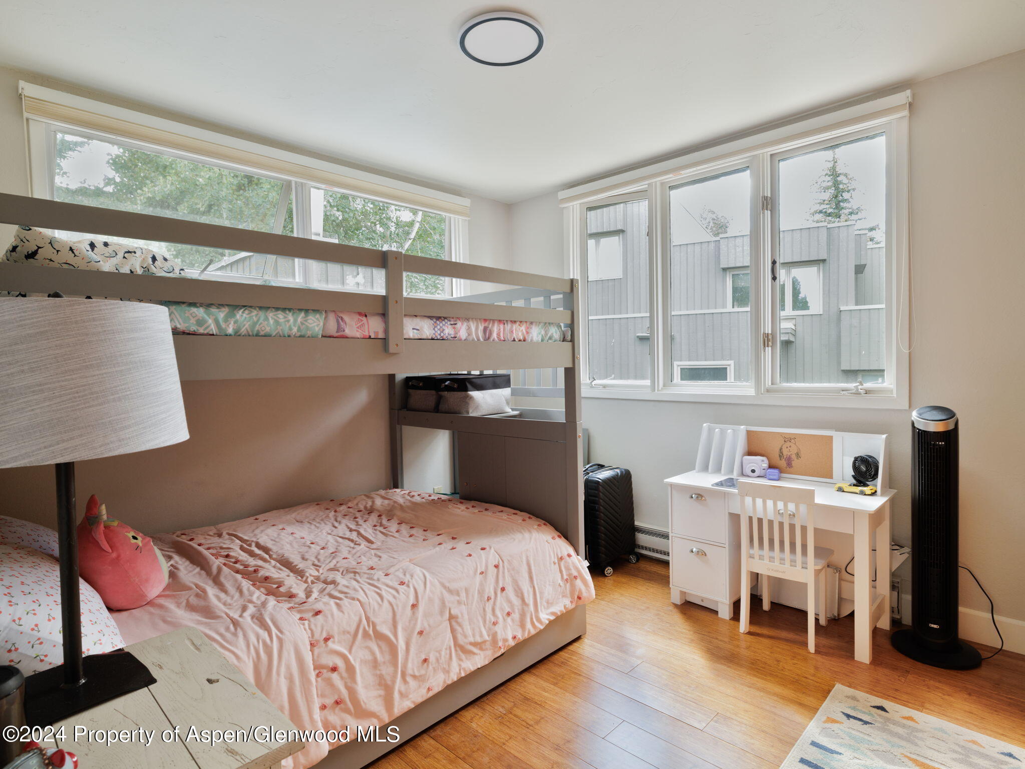 383 Meadow Ranch Road, Unit F4C Snowmass Village, CO 81615 - Photo 12 of 16 a bedroom with a bed a lamp and a large window