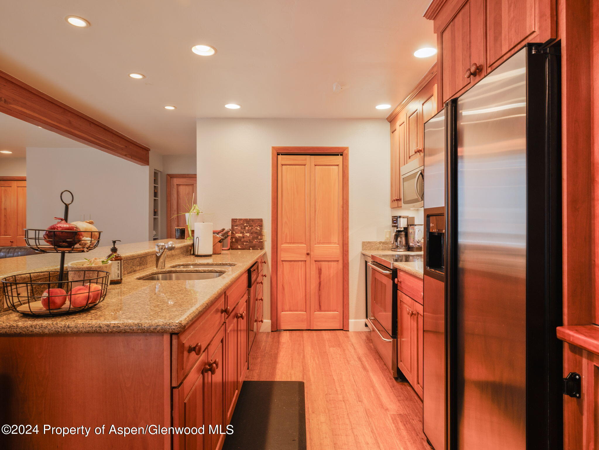 383 Meadow Ranch Road, Unit F4C Snowmass Village, CO 81615 - Photo 9 of 16 a kitchen with stainless steel appliances granite countertop a refrigerator a stove and a sink