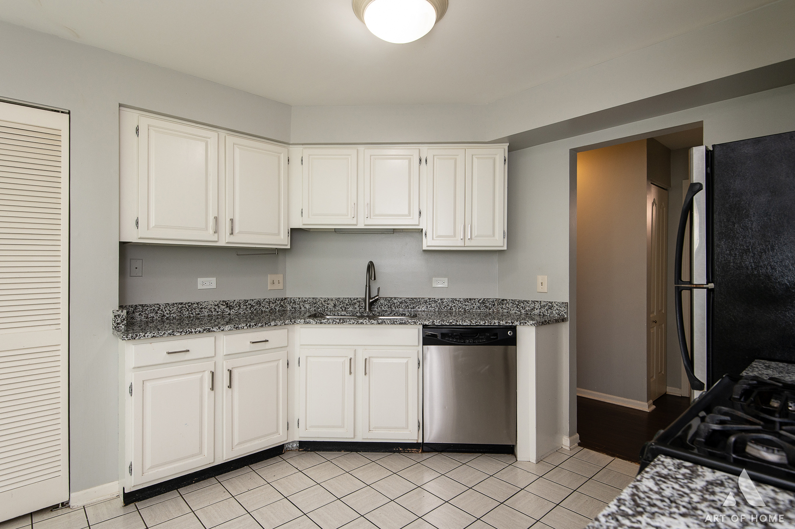61 Willow Parkway, Unit 61 Buffalo Grove, IL 60089 - Photo 12 of 34 a kitchen with granite countertop a sink cabinets and stainless steel appliances