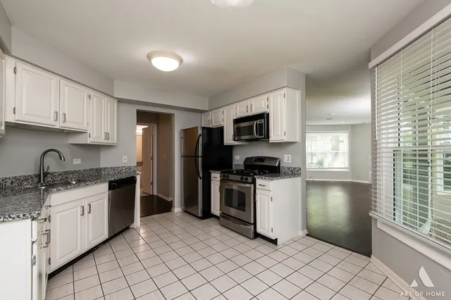 a kitchen with granite countertop appliances cabinets and a sink