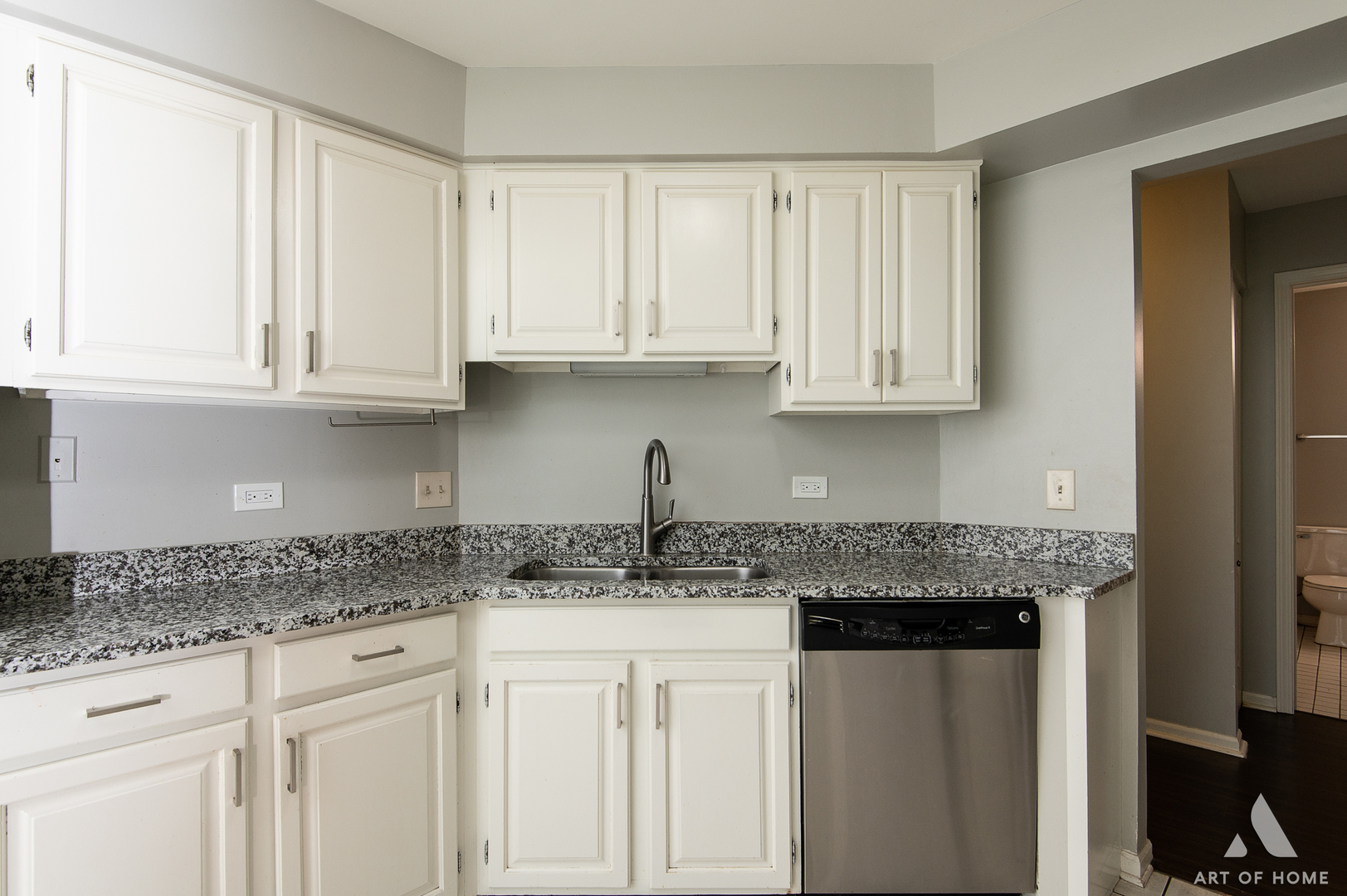 61 Willow Parkway, Unit 61 Buffalo Grove, IL 60089 - Photo 15 of 34 a kitchen with granite countertop white cabinets and a sink