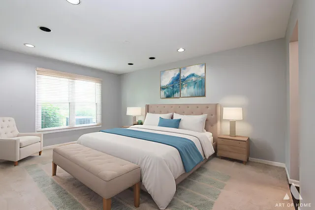 a bedroom with a bed and a large window