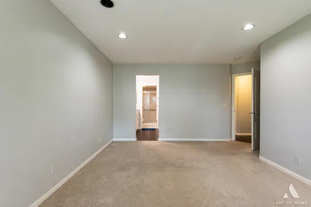 an empty room with windows and closet