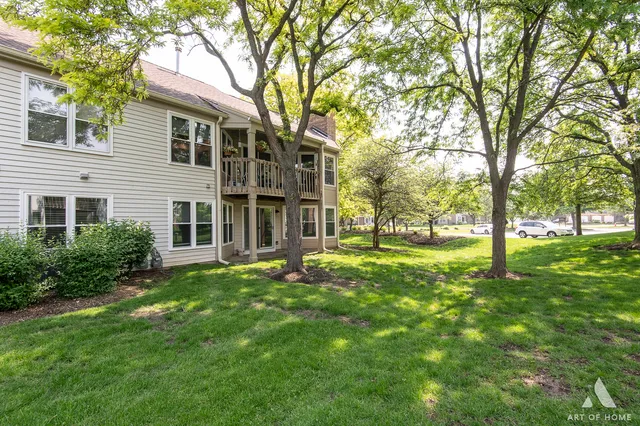 a view of a house with backyard and a tree