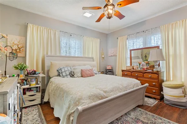 a bedroom with a bed and a chandelier