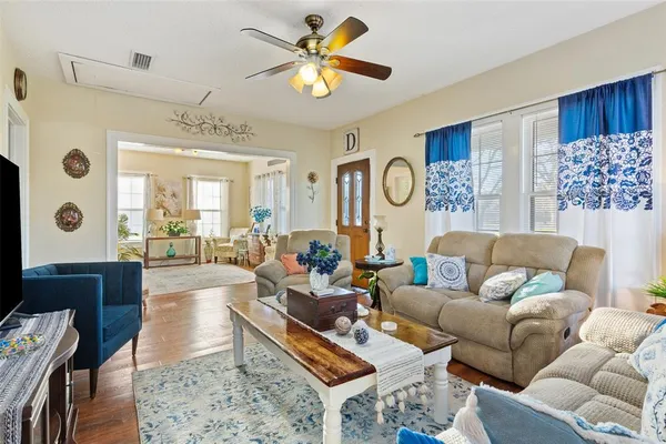 a living room with furniture fireplace and a large window