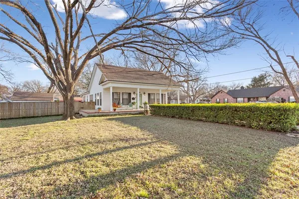 a house with a large tree in front of it
