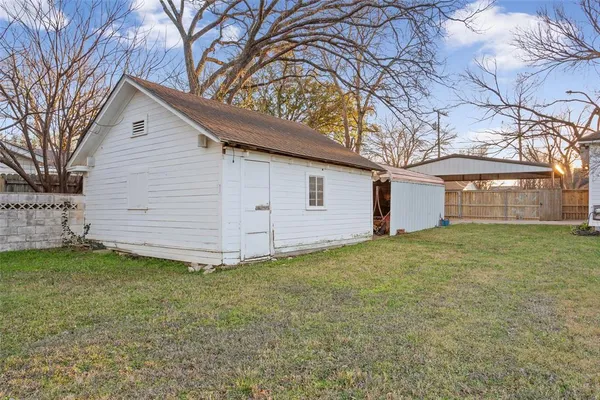 a view of a backyard with a large tree