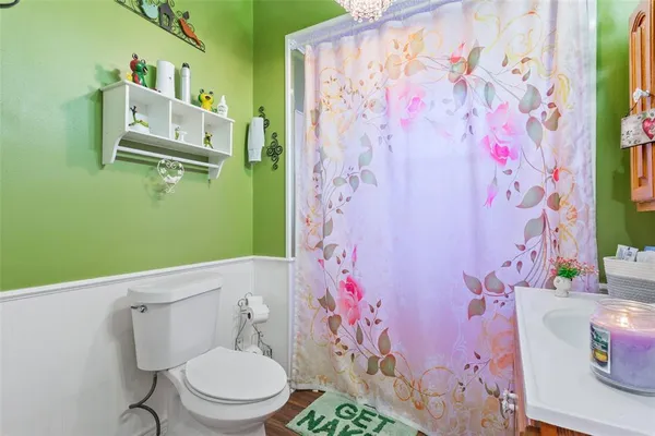 a white toilet sitting next to a shower curtain