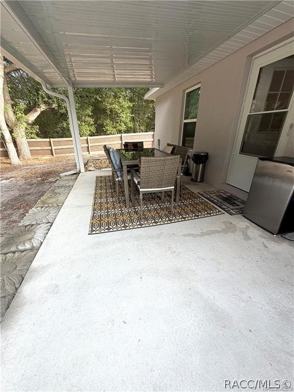 13591 Southwest 112th Street Dunnellon, FL 34432 - Photo 21 of 24 a view of a patio with a table chairs and balcony