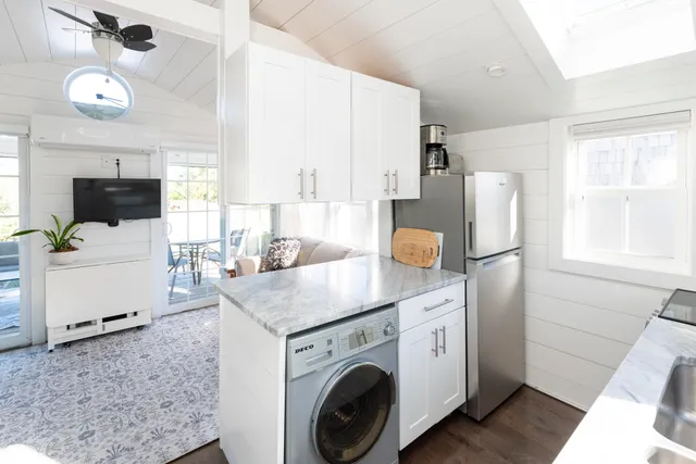 a utility room with cabinets washer and dryer