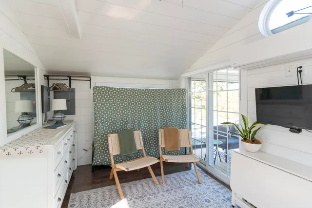 a view of a chairs and table in the balcony