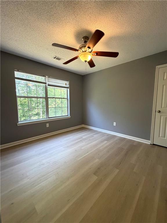 2205 Springer Walk Lawrenceville, GA 30043 - Photo 20 of 26 an empty room with windows and ceiling fan