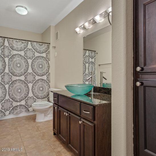3848 North 3rd Avenue, Unit 1086 Phoenix, AZ 85013 - Photo 17 of 35 a bathroom with a granite countertop sink a toilet and a mirror