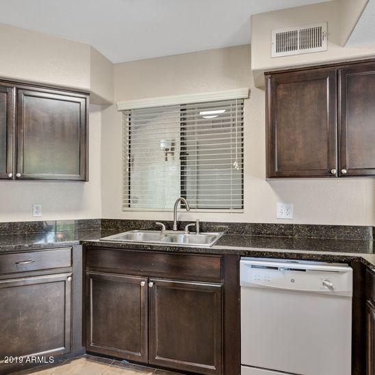 3848 North 3rd Avenue, Unit 1086 Phoenix, AZ 85013 - Photo 6 of 35 a sink with granite countertop a sink and cabinets
