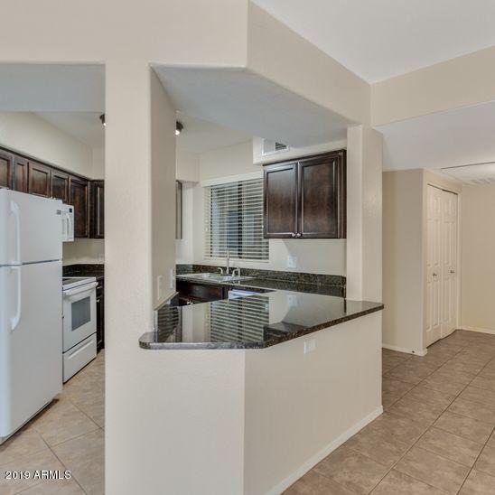 3848 North 3rd Avenue, Unit 1086 Phoenix, AZ 85013 - Photo 8 of 35 a kitchen with stainless steel appliances granite countertop a refrigerator and a sink