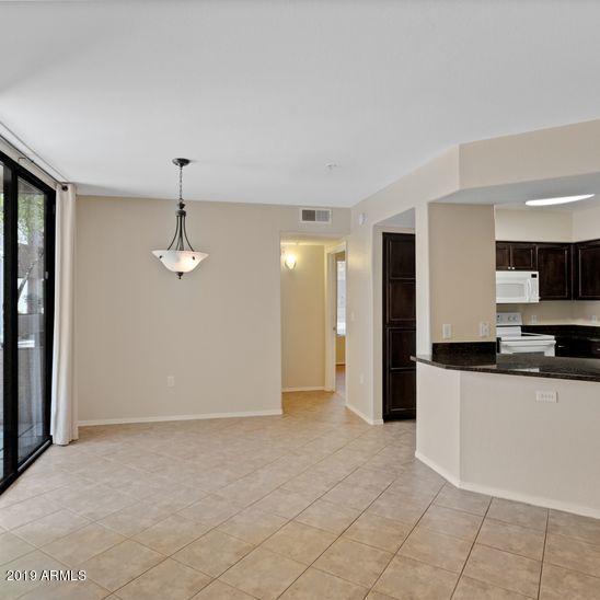 3848 North 3rd Avenue, Unit 1086 Phoenix, AZ 85013 - Photo 9 of 35 a kitchen with stainless steel appliances granite countertop a refrigerator a sink and a stove