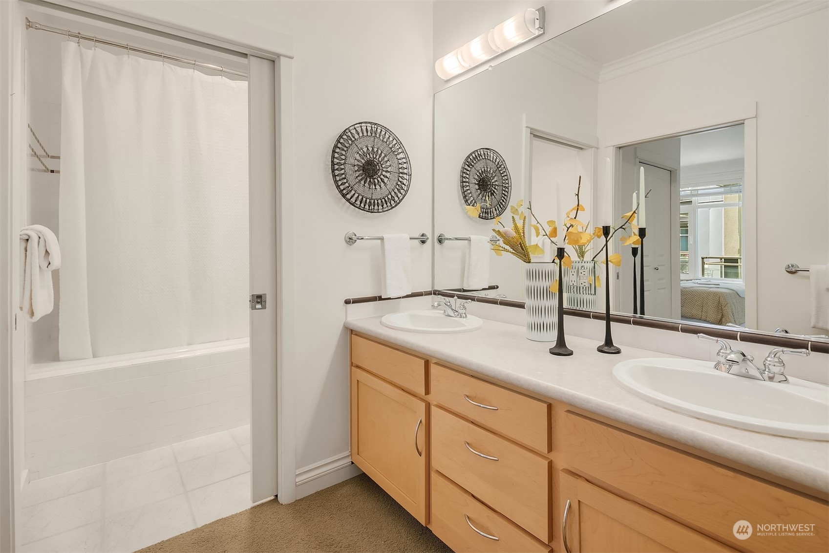 2000 Alaskan Way, Unit 442 Seattle, WA 98121 - Photo 14 of 23 a bathroom with a double vanity sink and a mirror