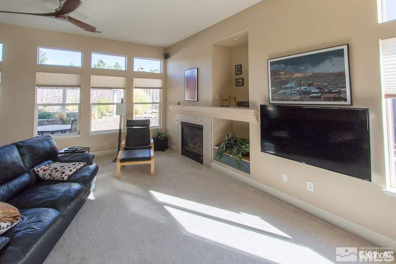 9760 Frankwood Drive Reno, NV 89521 - Photo 17 of 24 a living room with furniture a window and a fireplace