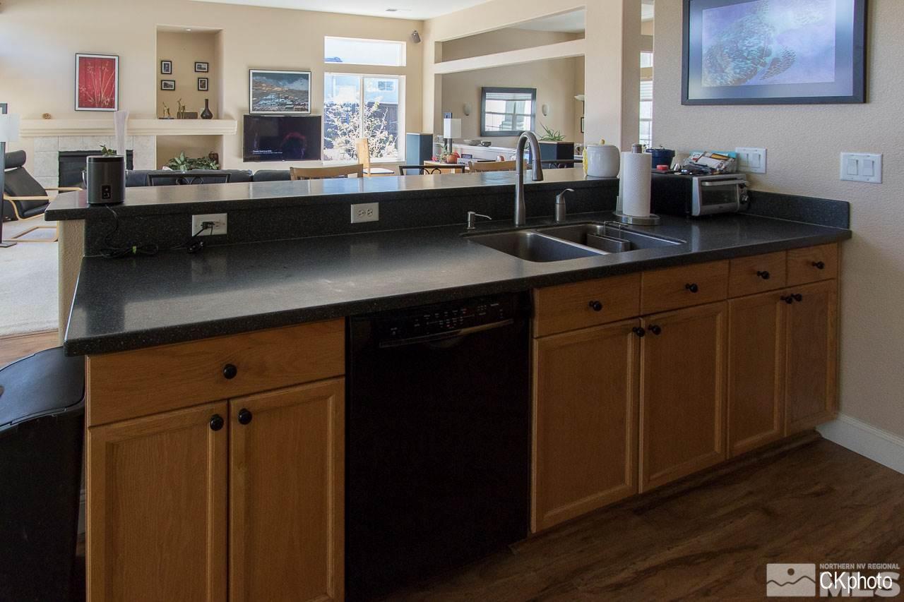 9760 Frankwood Drive Reno, NV 89521 - Photo 8 of 24 a kitchen with stainless steel appliances granite countertop a sink stove and cabinets