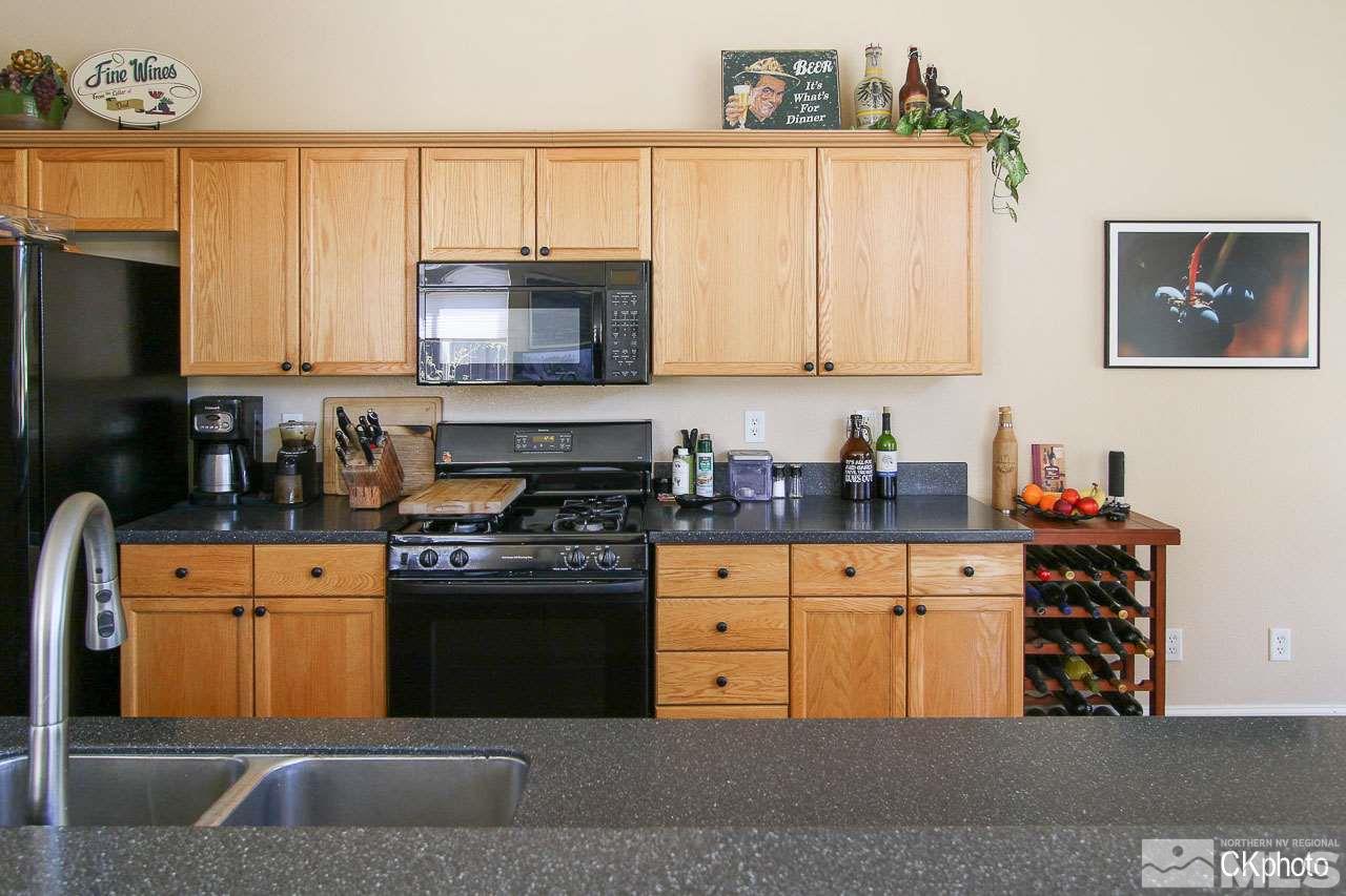 9760 Frankwood Drive Reno, NV 89521 - Photo 9 of 24 a kitchen with stainless steel appliances granite countertop a stove a sink and a refrigerator
