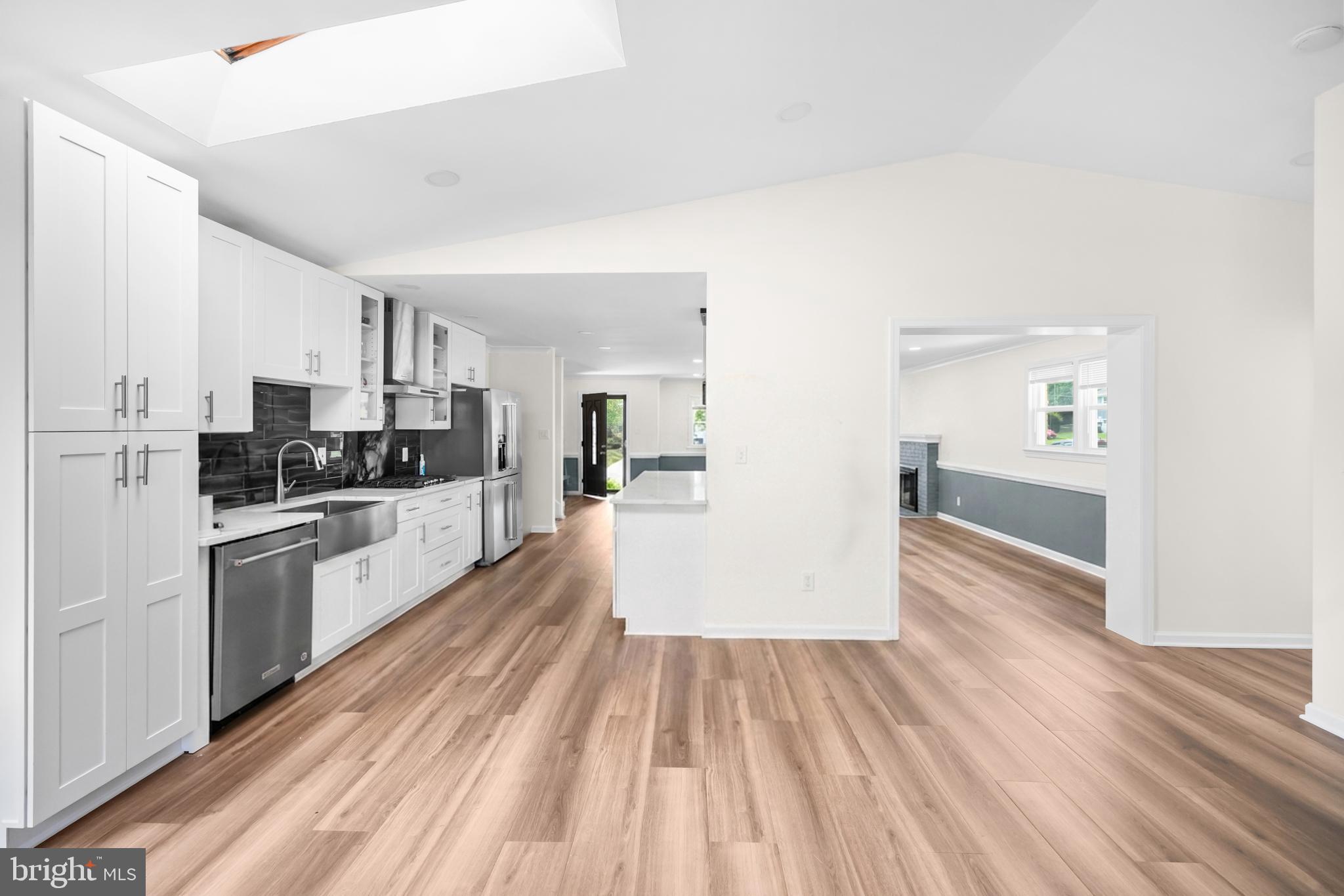 7402 Dunston Street Springfield, VA 22151 - Photo 12 of 37 a kitchen with wooden floors and appliances