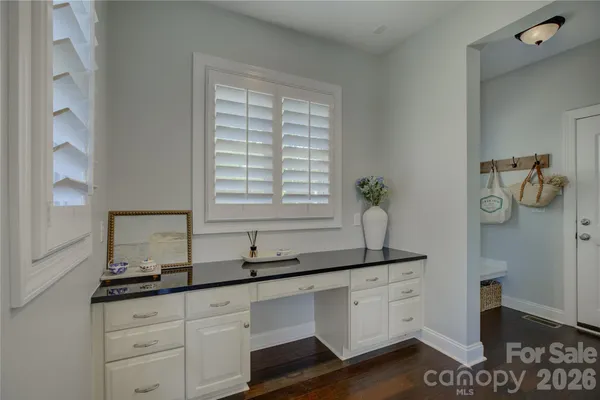 a bathroom with a granite countertop sink a toilet and a mirror