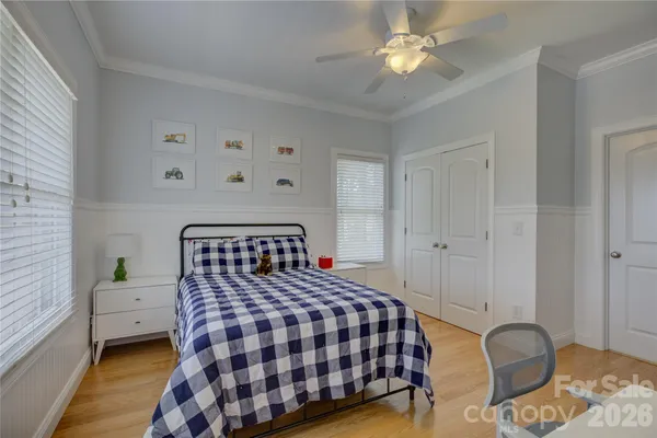 a bed room with a bed and a chair