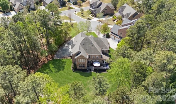 an aerial view of a house with a garden and trees