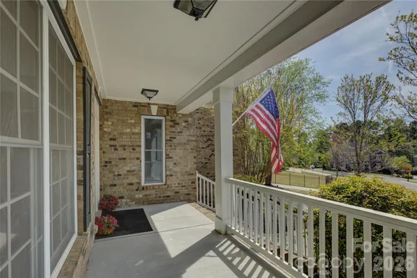 a view of balcony with wooden floor and fence