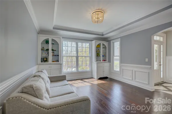 a kitchen with stainless steel appliances kitchen island granite countertop a dining table chairs and white cabinets