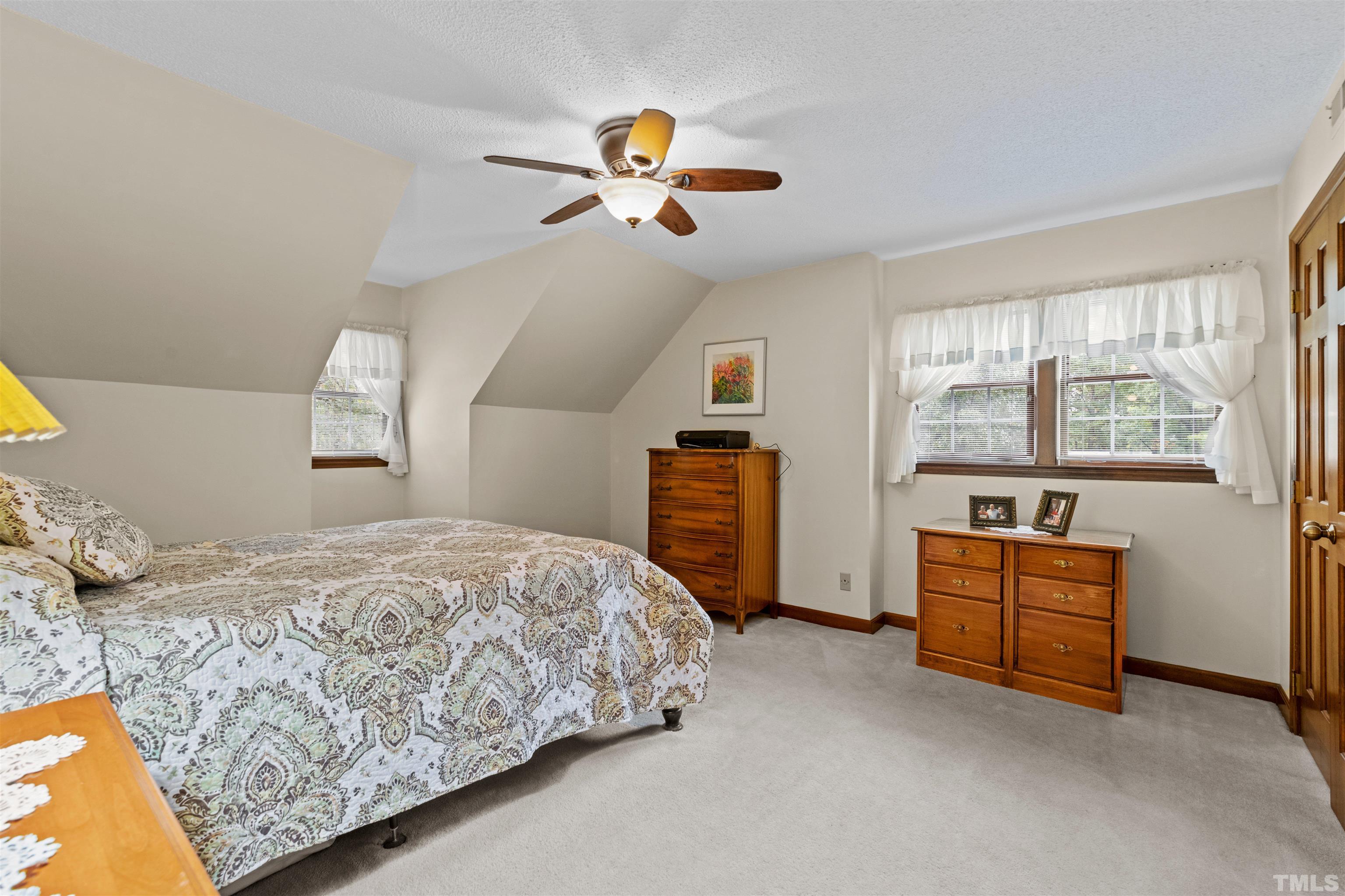 8417 Crowder Road Raleigh, NC 27603 - Photo 20 of 30 a bedroom with a bed and wooden floor