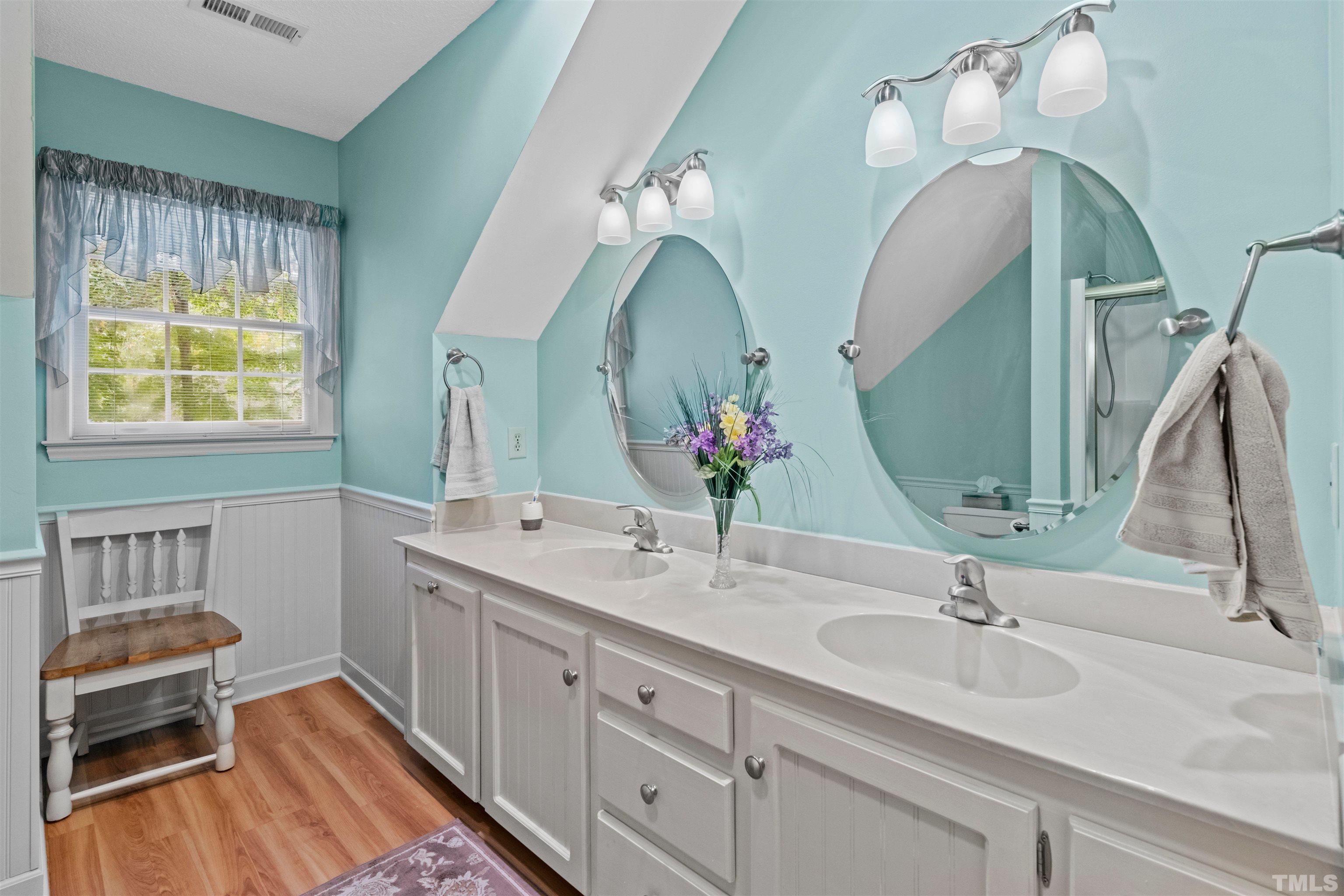 8417 Crowder Road Raleigh, NC 27603 - Photo 23 of 30 a bathroom with a sink and a mirror