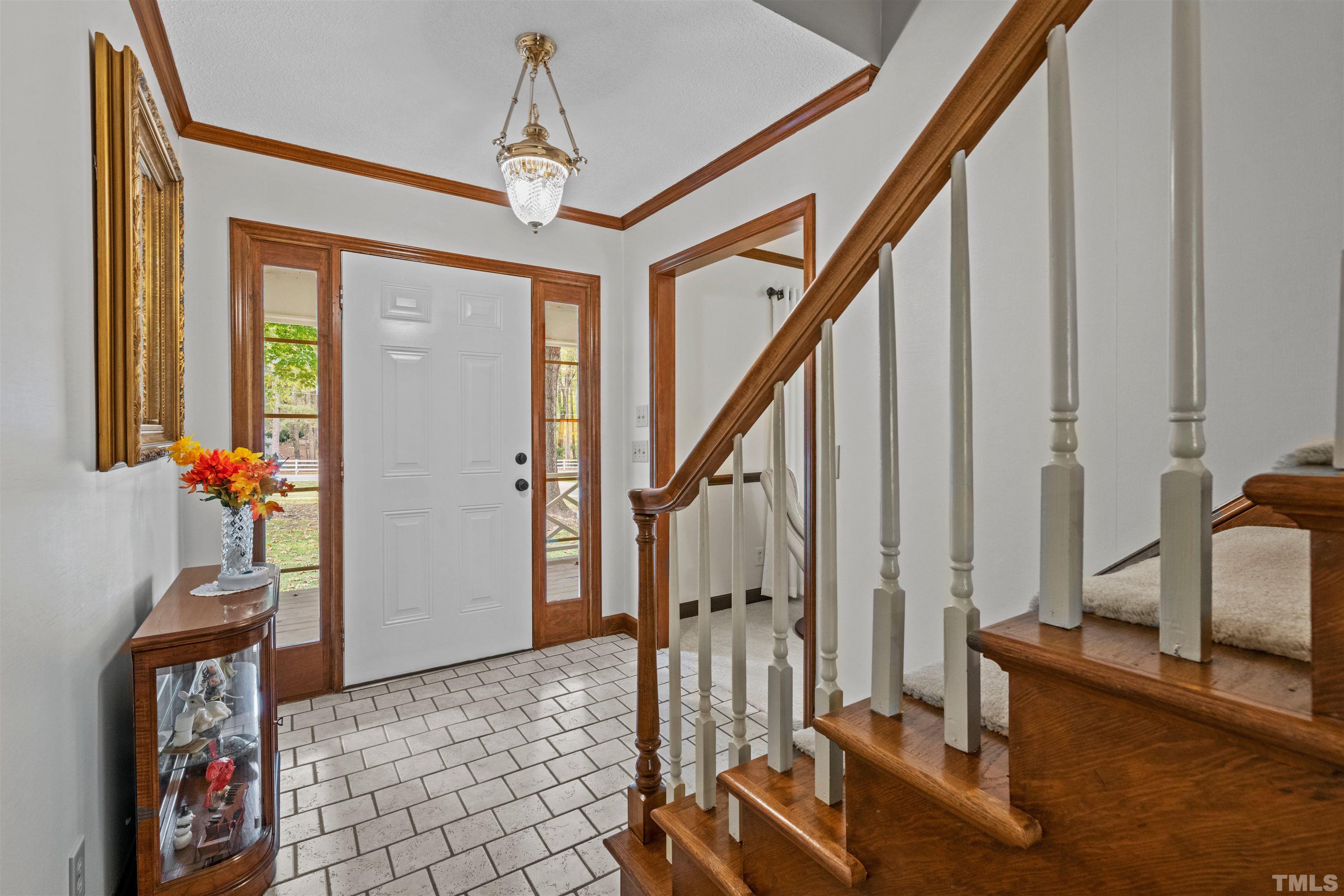 8417 Crowder Road Raleigh, NC 27603 - Photo 8 of 30 a view of an entryway with wooden floor and windows