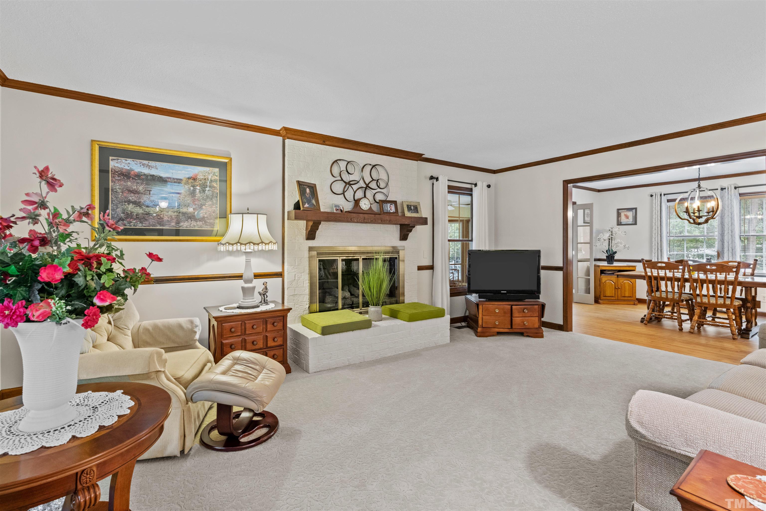 8417 Crowder Road Raleigh, NC 27603 - Photo 10 of 30 a living room with furniture and a flat screen tv