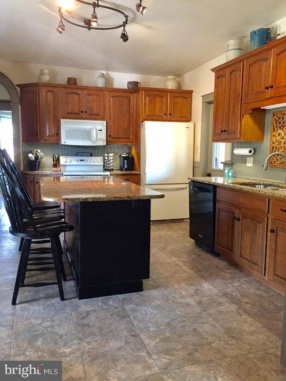 737 Penn Avenue Lititz, PA 17543 - Photo 11 of 35 a kitchen with stainless steel appliances granite countertop a stove top oven a sink dishwasher and cabinets