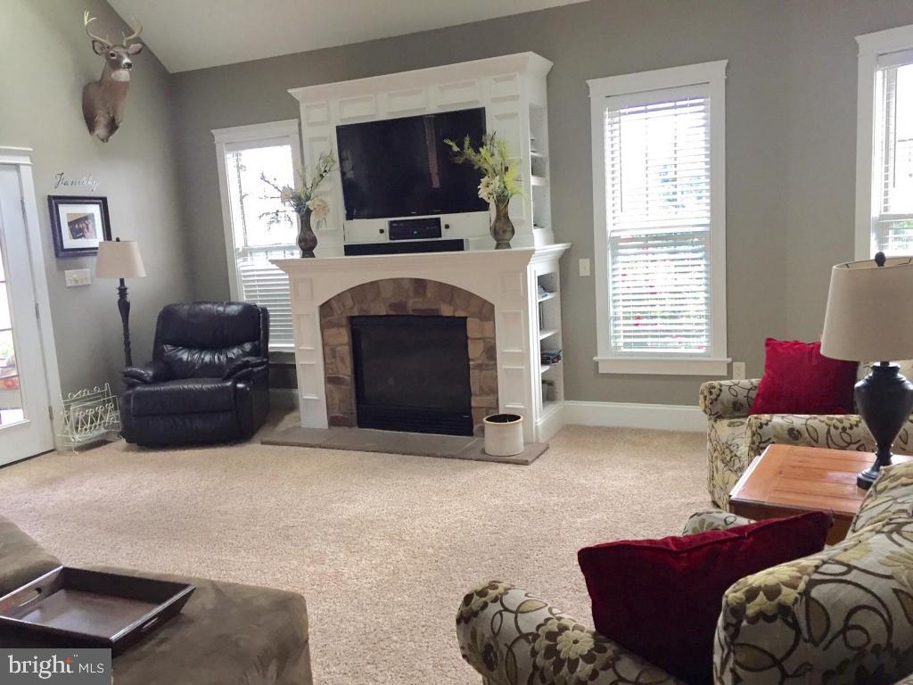 737 Penn Avenue Lititz, PA 17543 - Photo 16 of 35 a living room with furniture a flat screen tv and a fireplace
