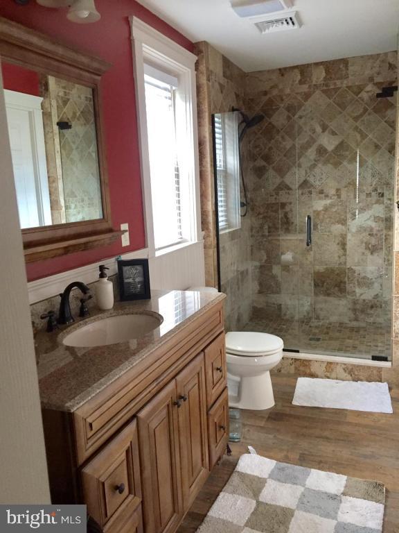 737 Penn Avenue Lititz, PA 17543 - Photo 19 of 35 a bathroom with a granite countertop sink toilet a mirror and shower