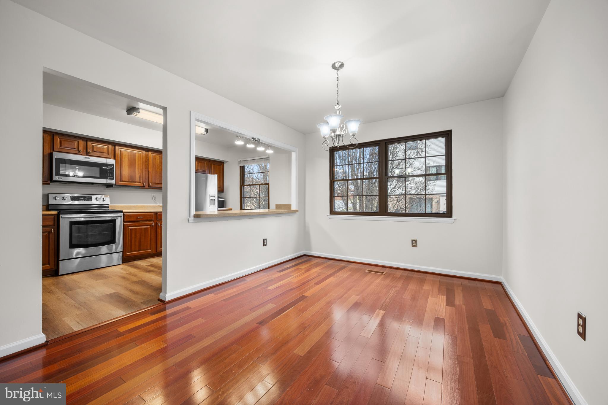 33 Badger Gate Court Baltimore, MD 21228 - Photo 13 of 39 an empty room with wooden floor fireplace and windows